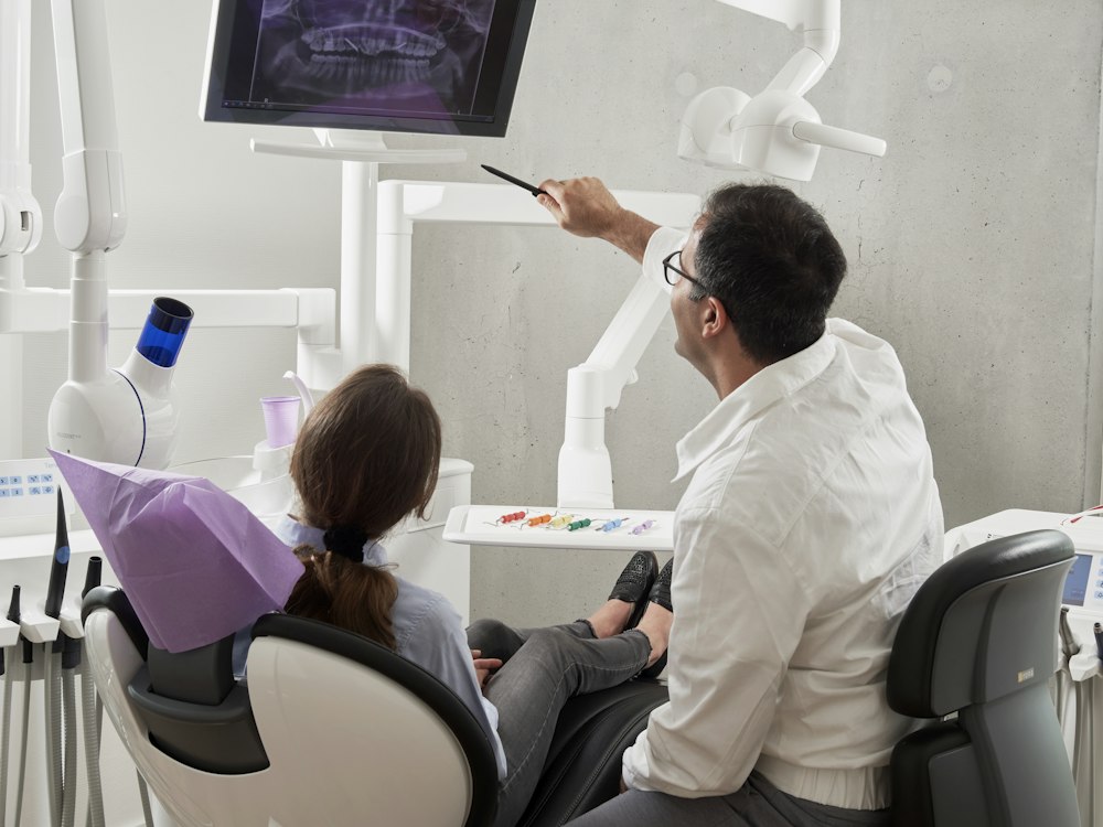 Dentist discussing a dental image with a patient